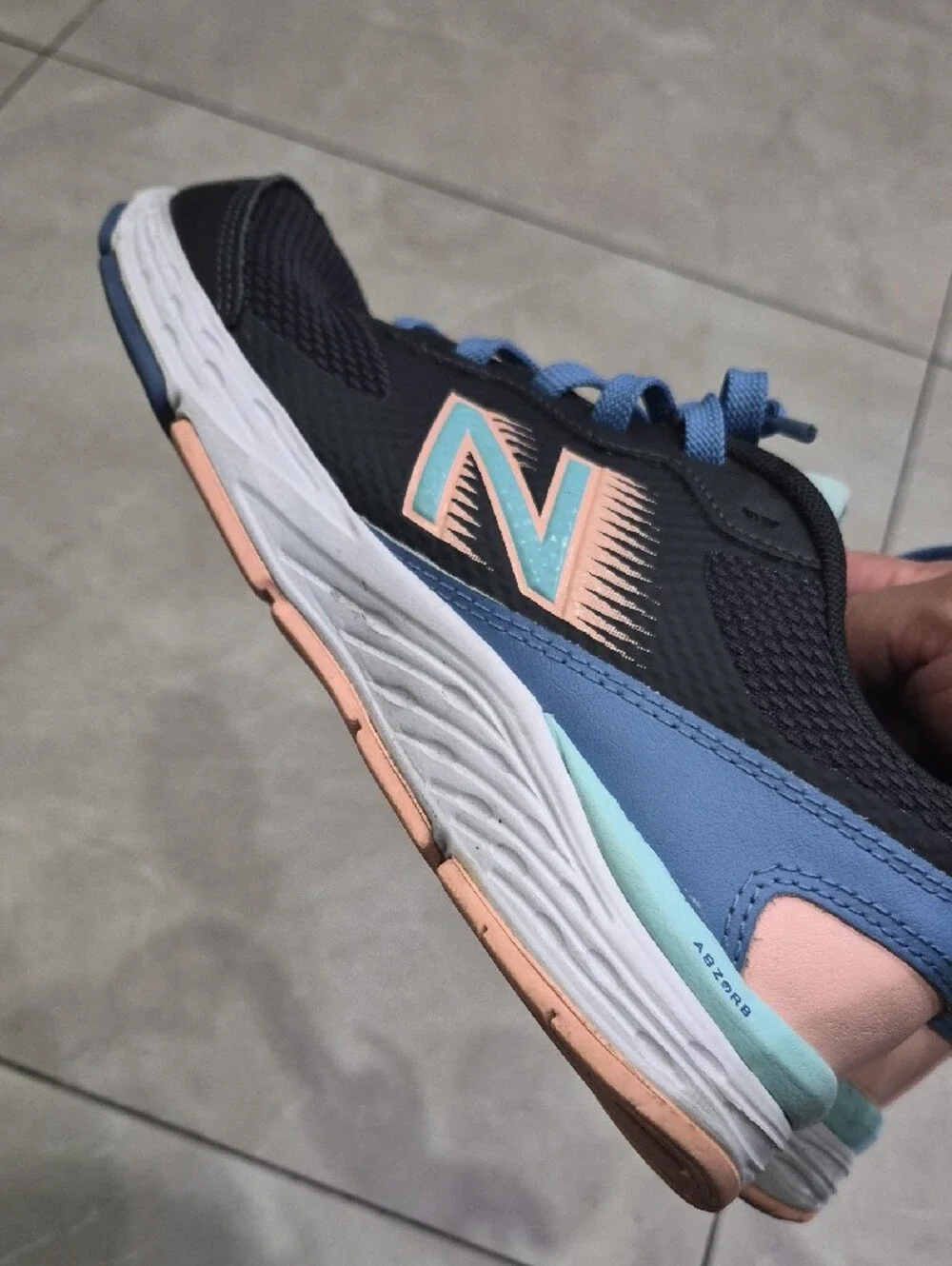 New Balance Women's Black Athletic Sneakers with Blue Laces and Peach Accents